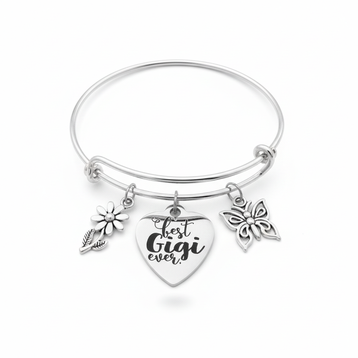 Silver expandable wire bangle bracelet with Best Gigi Ever engraved heart charm, daisy flower charm, and butterfly charm on white background – Jules Obsession