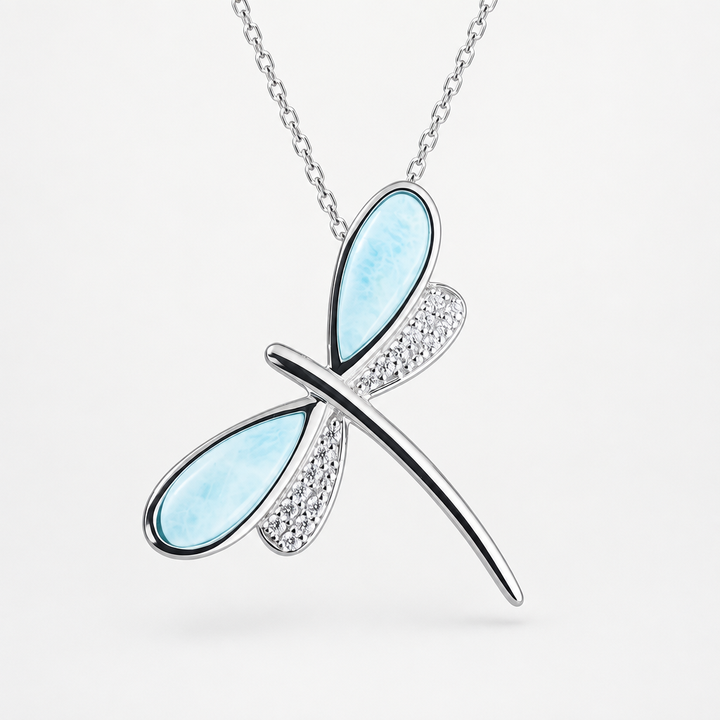 Sterling silver dragonfly necklace with pale blue Larimar wings and sparkling pavé details on a light studio background.