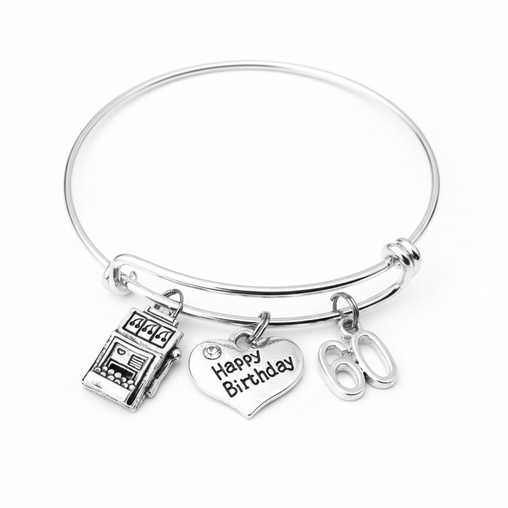 Silver expandable 60th birthday charm bracelet with slot machine charm, Happy Birthday heart charm with crystal accent, and 60 number charm on white background