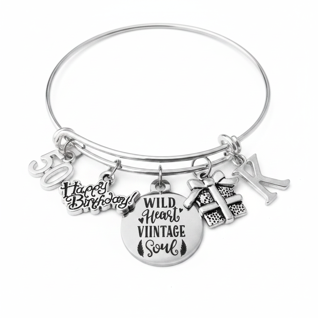 Silver expandable bangle bracelet with 50 number charm, Happy Birthday script charm, Wild Heart Vintage Soul round engraved medallion, gift box charm, and personalized initial charm — handmade by Jules Obsession