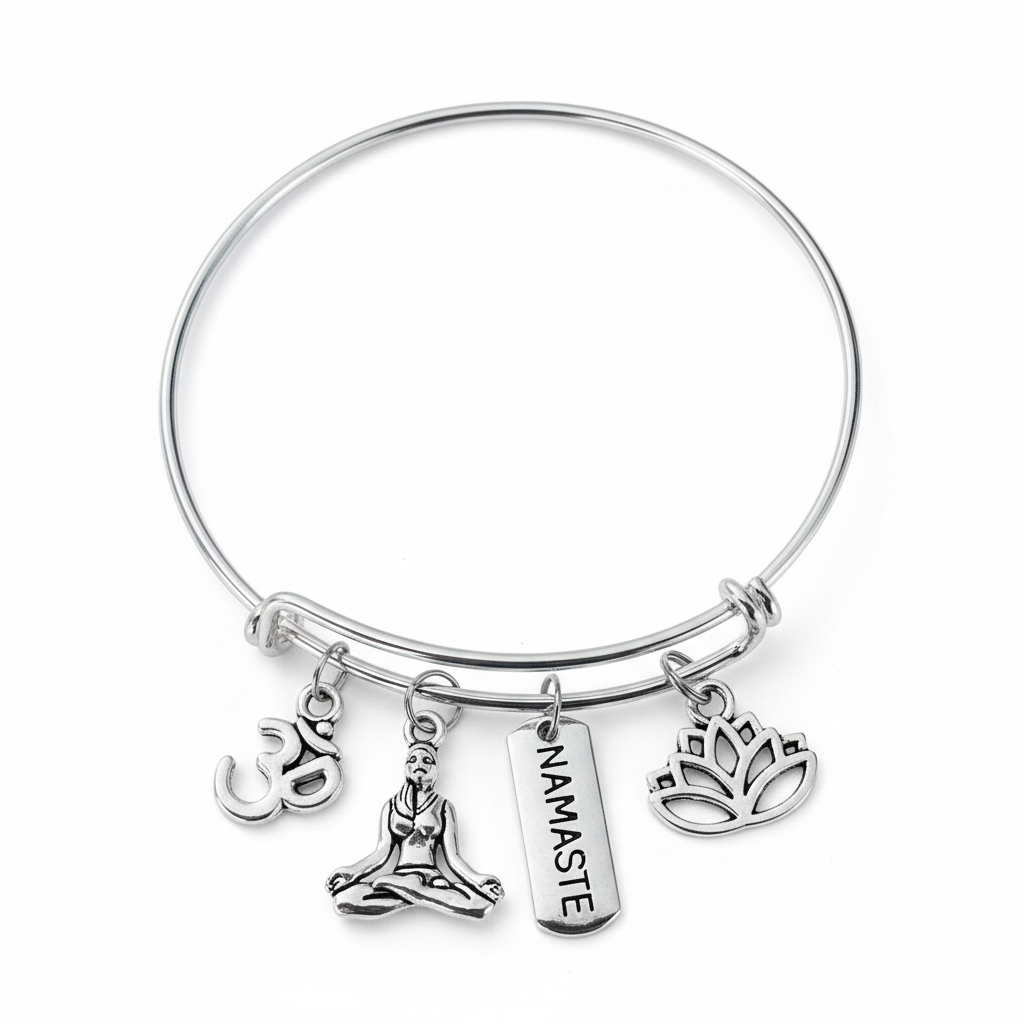 Silver expandable bangle bracelet with an Om symbol, seated meditation figure, NAMASTE tag, and lotus charm on a clean white studio background