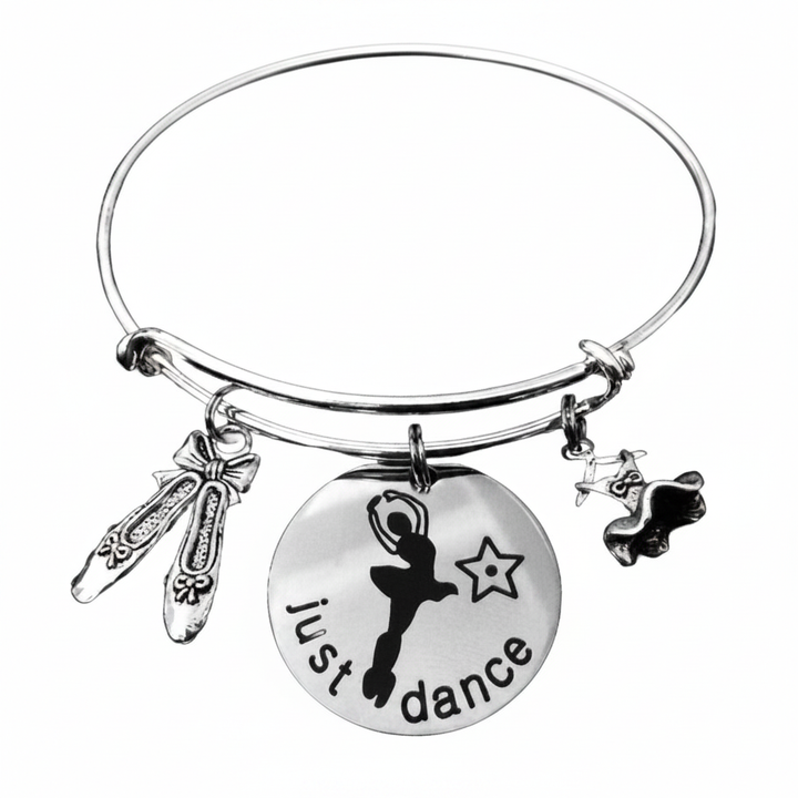 Silver expandable bangle bracelet with ballet pointe shoe charm with bow, large round just dance disc engraved with ballerina arabesque silhouette and star, and silver ballet tutu charm — meaningful dance recital gift for ballet dancers and dance teachers