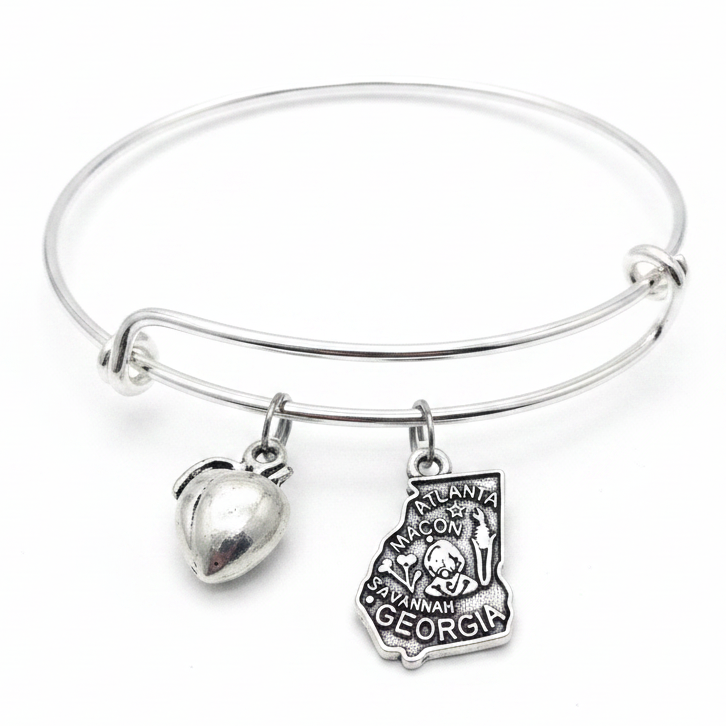 Silver expandable bangle bracelet with two charms: puffy silver heart charm and detailed Georgia state shape charm engraved with Atlanta, Macon, Savannah and Georgia landmarks — adjustable stackable gift bracelet for Georgia lovers and women