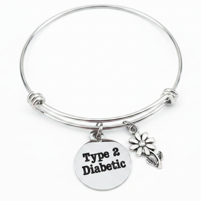 Silver expandable bangle bracelet with Type 2 Diabetic engraved disc charm and daisy flower charm  on white background