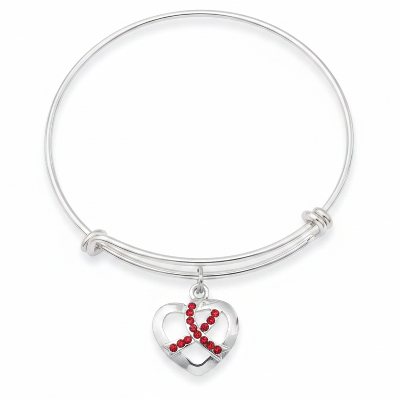 Silver expandable bangle bracelet with open-cut heart charm featuring red crystal rhinestone awareness ribbon on white background overhead view - Jules Obsession