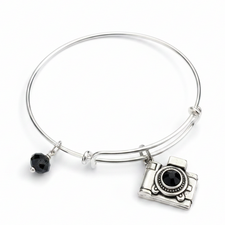 Silver expandable bangle bracelet with vintage camera charm featuring black crystal lens and faceted black crystal bead — photographer gift bracelet by Jules Obsession