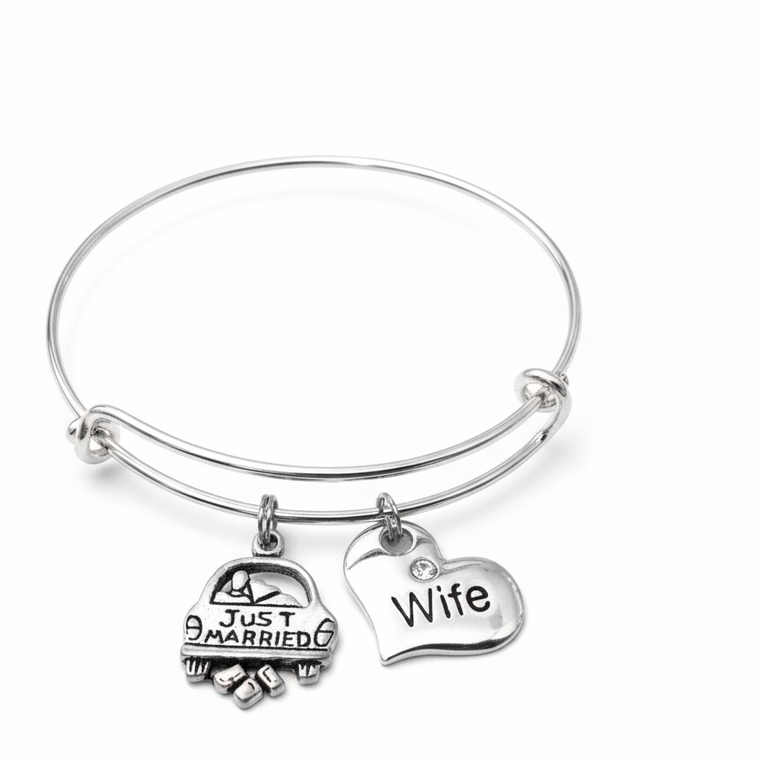 Silver expandable bangle bracelet with Just Married car charm and Wife engraved crystal heart charm on white background