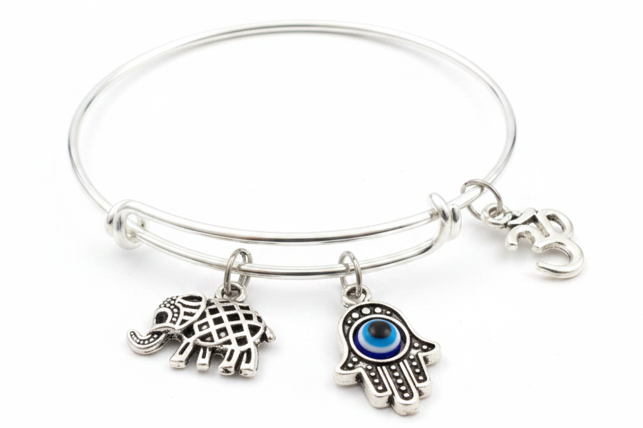 Silver expandable bangle bracelet with Hamsa hand evil eye charm, Om symbol charm, and lucky elephant charm on white background – Jules Obsession spiritual protection jewelry