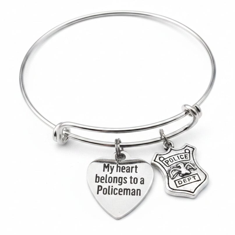 Professional white background studio photo of silver bracelet with My Heart Belongs to a Policeman engraved heart charm and police dept badge charm – law enforcement wife jewelry
