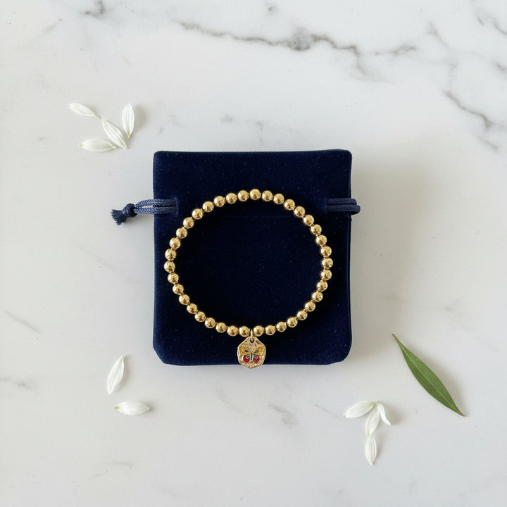 Gold bead butterfly enamel charm stretch bracelet gift-ready in dark velvet jewelry pouch – butterfly gift by Jules Obsession