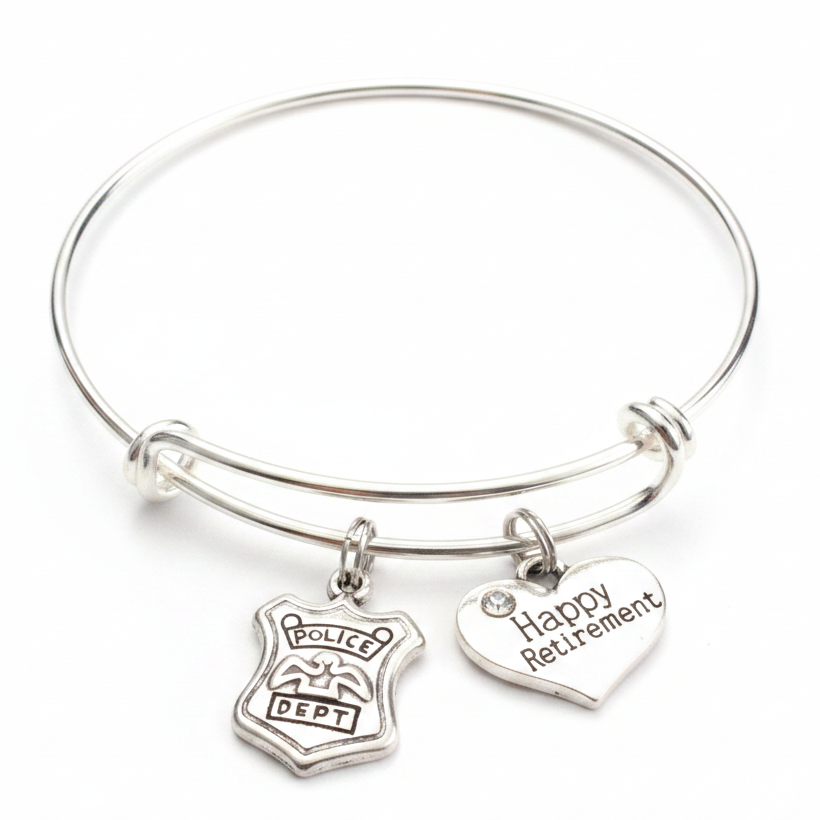 Silver expandable bangle bracelet with two charms: Police Dept badge charm with eagle emblem and silver heart charm engraved Happy Retirement with crystal accent — adjustable stackable retirement gift bracelet for women police officers