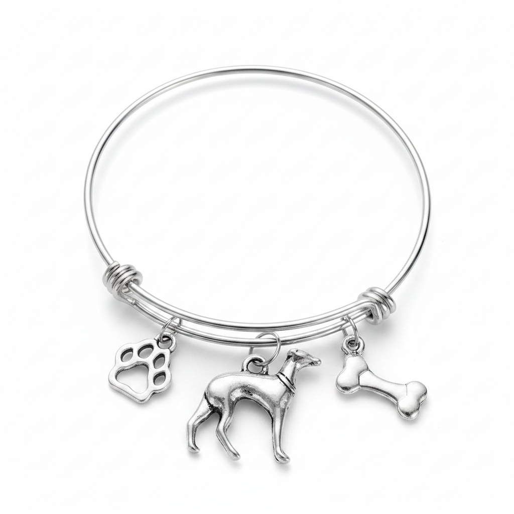 Silver expandable bangle bracelet with three antique silver dog-themed charms: a paw print charm, a greyhound dog figurine charm, and a bone charm, displayed on a white studio background