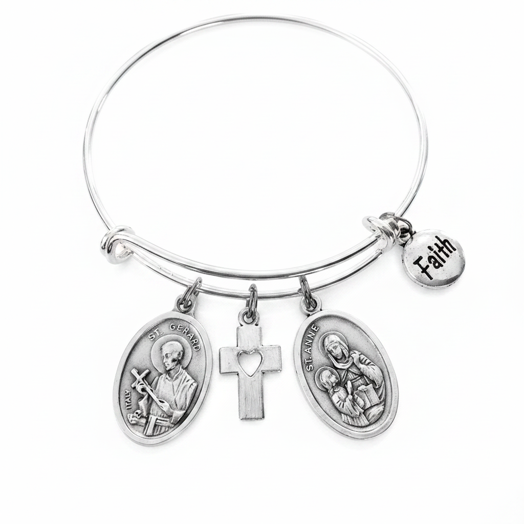 Silver expandable bangle bracelet with Saint Gerard Italy oval medal, heart cross charm, Saint Anne oval medal, and Faith disc charm — Catholic fertility and pregnancy gift jewelry by Jules Obsession