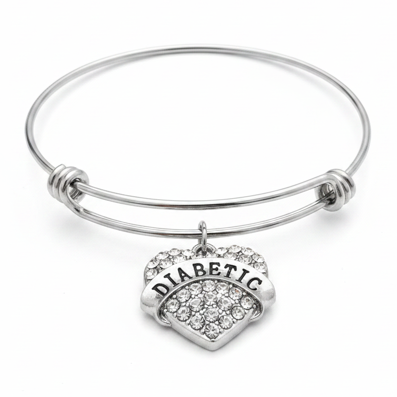 Diabetic medical alert bracelet with crystal rhinestone heart charm on expandable silver wire bangle, studio photo on white background