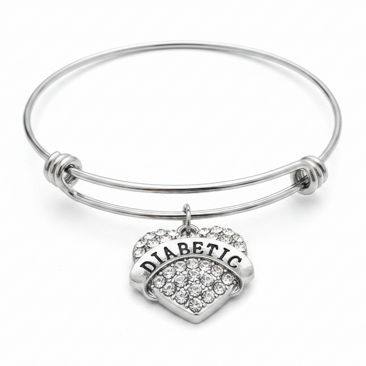 Diabetic medical alert bracelet with crystal rhinestone heart charm on expandable silver wire bangle, studio photo on white background