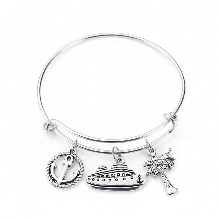 Silver-tone nautical cruise bracelet with anchor, cruise ship, and palm tree charms on a white studio background