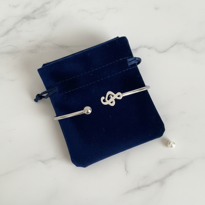 Treble clef stainless steel cuff bracelet gift-ready in dark velvet jewelry pouch – music note bangle by Jules Obsession