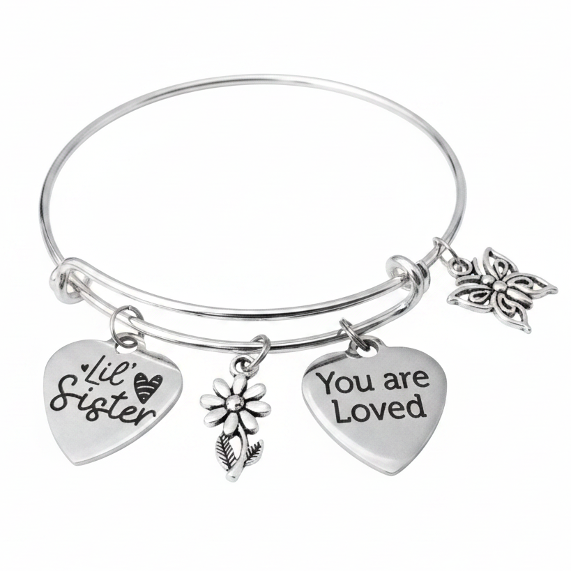 Silver expandable charm bangle bracelet featuring Lil Sister and You Are Loved heart charms, daisy flower charm, and butterfly charm on white studio background