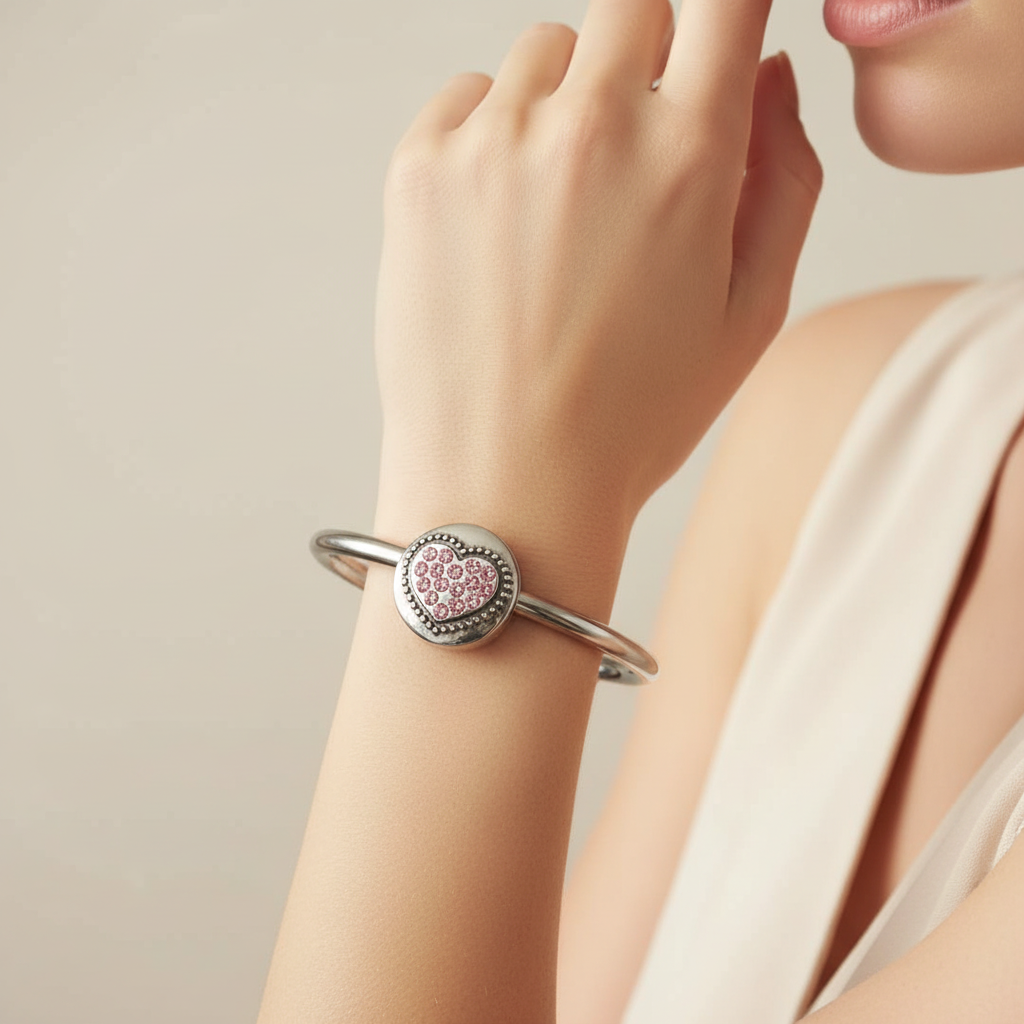 Woman wearing silver cuff bracelet with pink crystal rhinestone heart snap charm – interchangeable 18mm snap bracelet by Jules Obsession