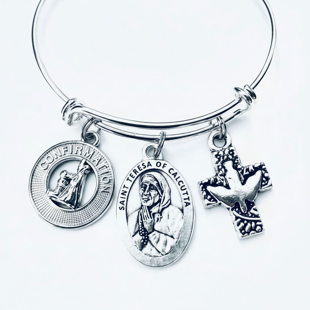 Silver-plated expandable charm bangle bracelet featuring Saint Teresa of Calcutta oval medal, Confirmation round medallion, and ornate dove cross charm — Catholic Confirmation gift for women and teens