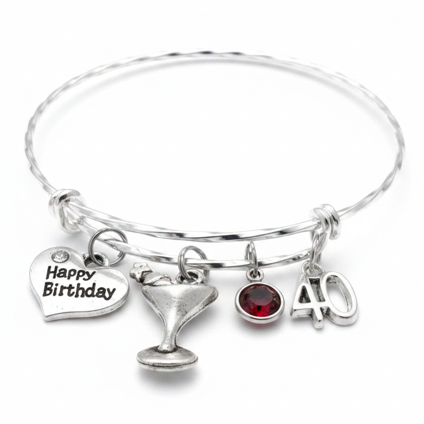 Silver twisted wire expandable 40th birthday charm bracelet with Happy Birthday heart, martini glass, garnet birthstone crystal, and number 40 charms on white background - Jules Obsession