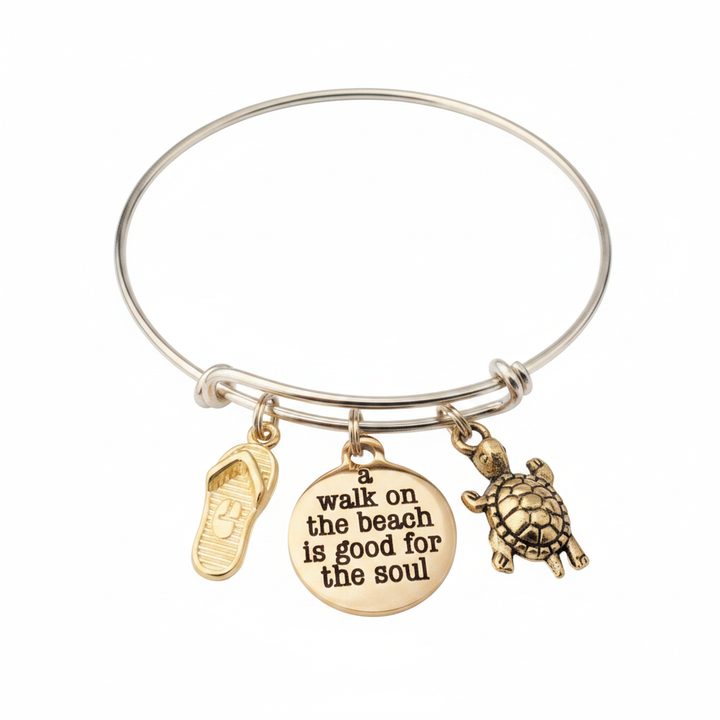 Gold-tone expandable bangle bracelet with three charms: gold flip flop sandal, engraved round disc reading a walk on the beach is good for the soul, and detailed gold sea turtle charm — adjustable stackable beach gift bracelet for women