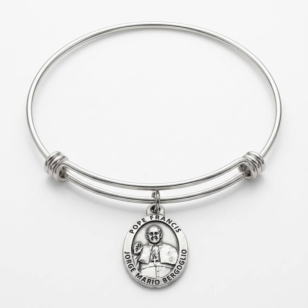 Full expandable stainless steel bangle with an attached oval Pope Francis silver-plated medal on a white studio background.