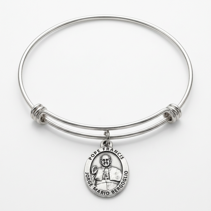 Full expandable stainless steel bangle with an attached oval Pope Francis silver-plated medal on a white studio background.