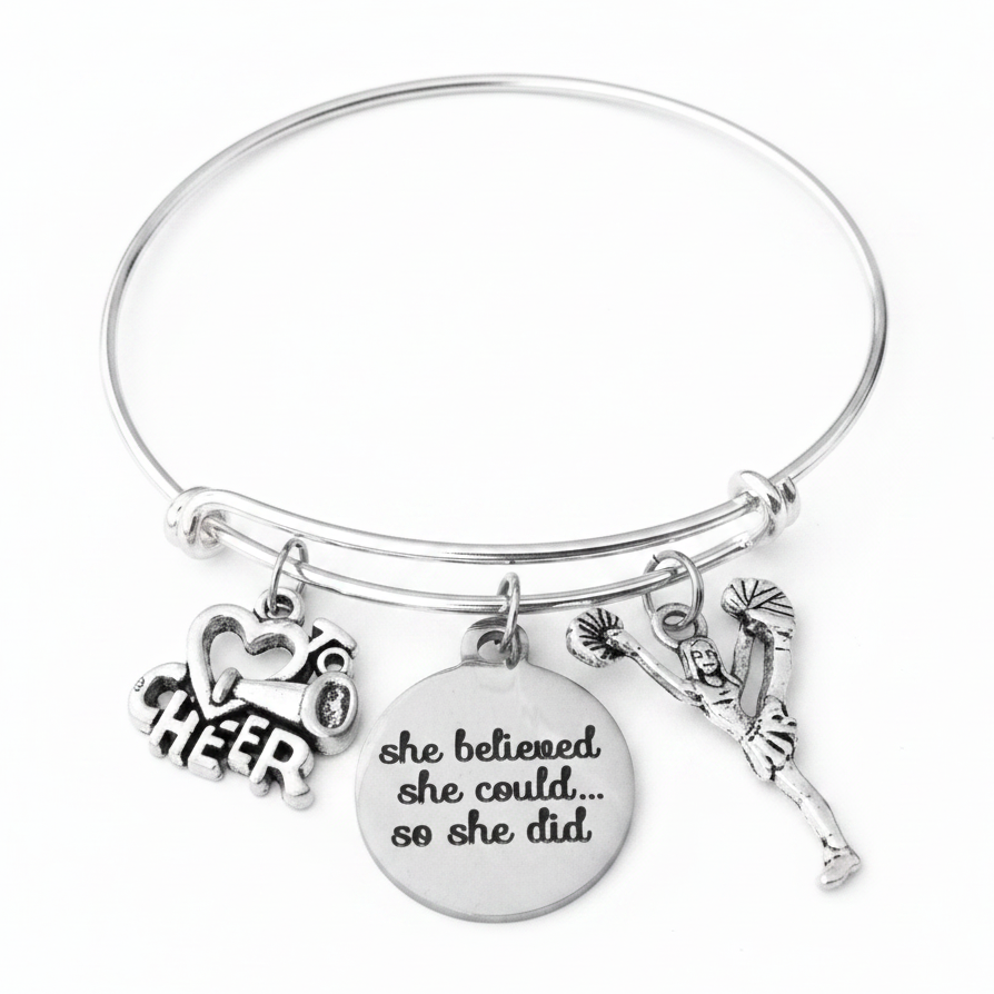 Silver expandable charm bangle bracelet with CHEER megaphone charm, she believed she could so she did engraved disc charm, and cheerleader figure charm, handcrafted by Jules Obsession