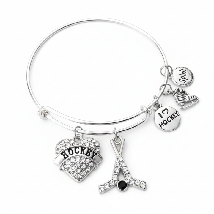 I Love Hockey silver expandable charm bangle bracelet with crystal heart charm, hockey sticks charm, ice skate charm, I Love Hockey disc charm, and Spirit charm on white background