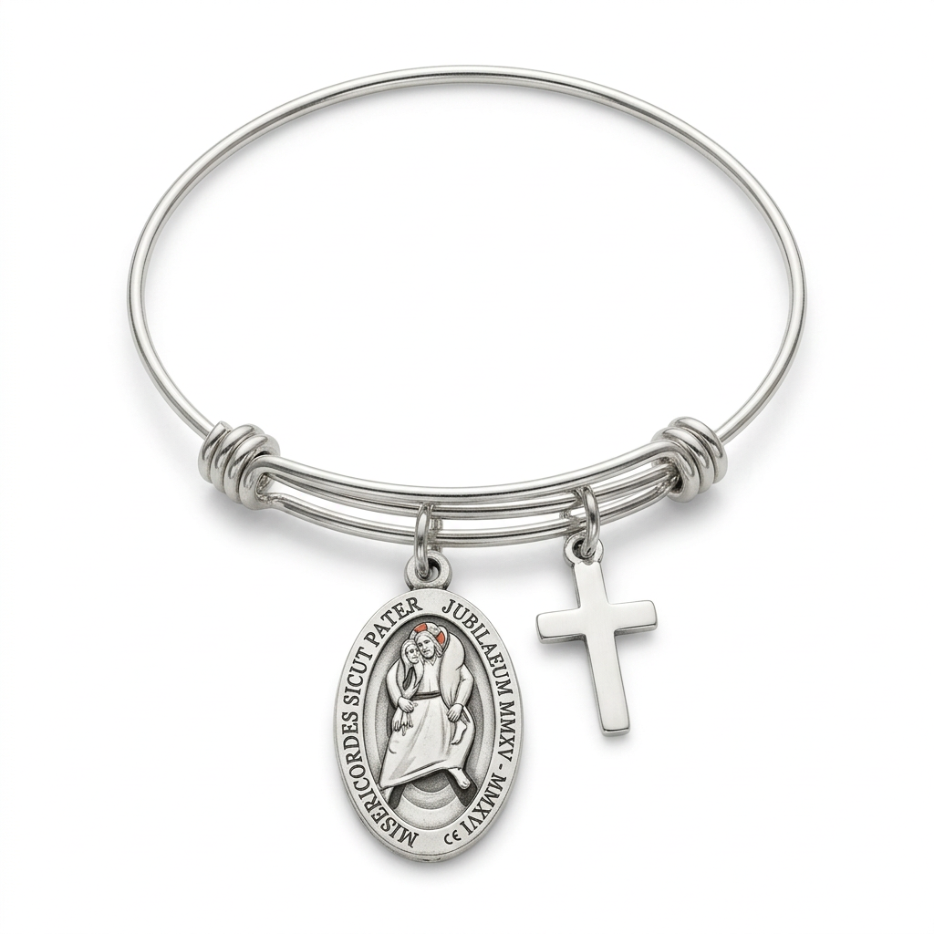 Expandable stainless steel bangle with Jubilee of Mercy oval medal and attached cross charm on a white studio background.
