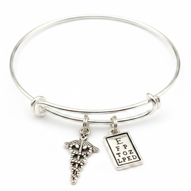 Silver expandable bangle bracelet with caduceus medical symbol charm and eye chart charm on white background – Jules Obsession optometrist eye doctor gift jewelry