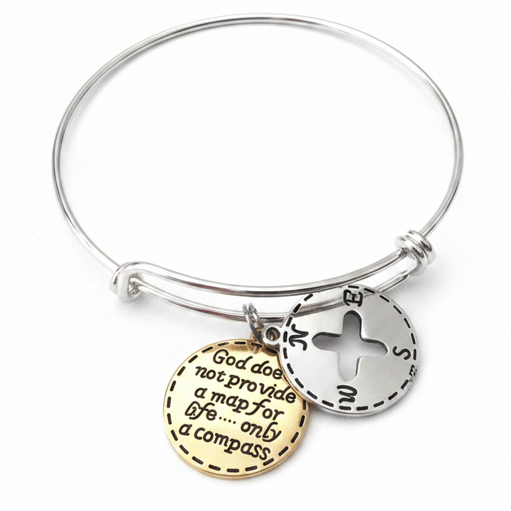 Silver expandable bangle bracelet with gold engraved compass quote charm and silver compass cardinal directions charm, full circle view on white background