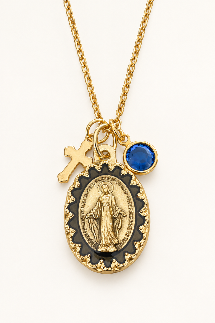 Gold-tone necklace with an oval religious medal, a small gold cross charm, and a round birthstone charm.