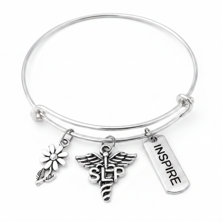 Silver expandable bangle bracelet with SLP caduceus charm, daisy flower charm, and Inspire tag charm on white studio background