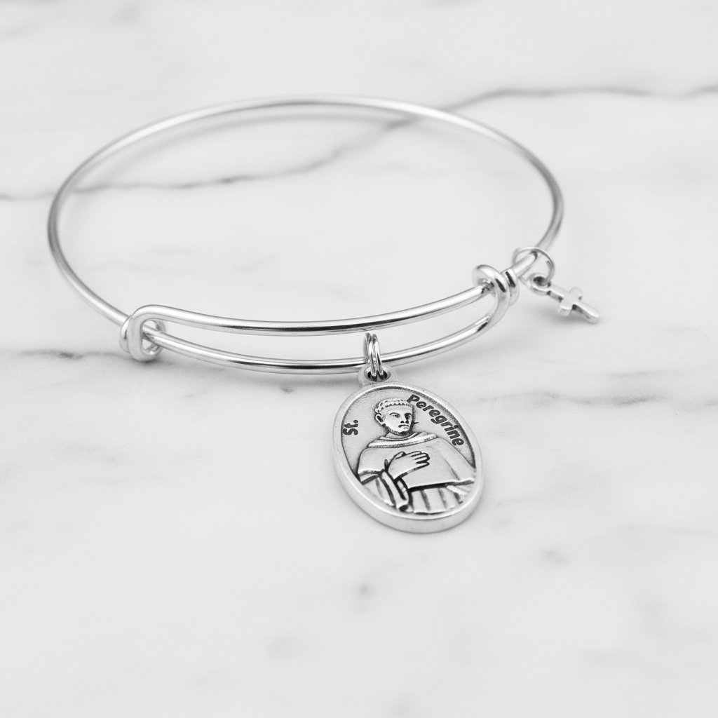Close-up of St. Peregrine antique silver oval relic medal charm on expandable wire bangle bracelet