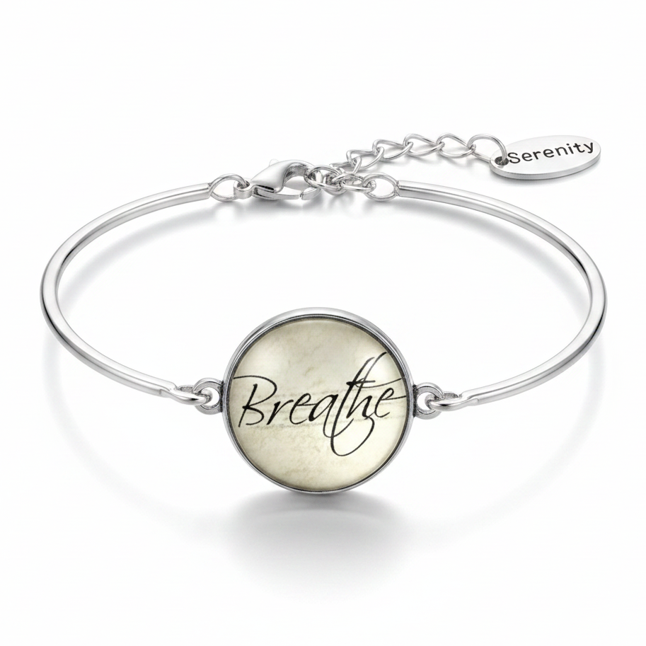 Breathe glass dome silver cuff bracelet with single Serenity oval tag charm on pure white background – mindfulness jewelry by Jules Obsession