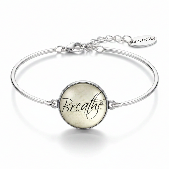 Breathe glass dome silver cuff bracelet with single Serenity oval tag charm on pure white background – mindfulness jewelry by Jules Obsession