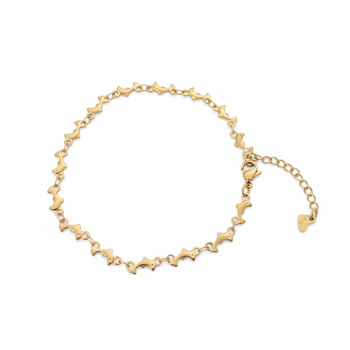 Gold dolphin chain anklet on white background