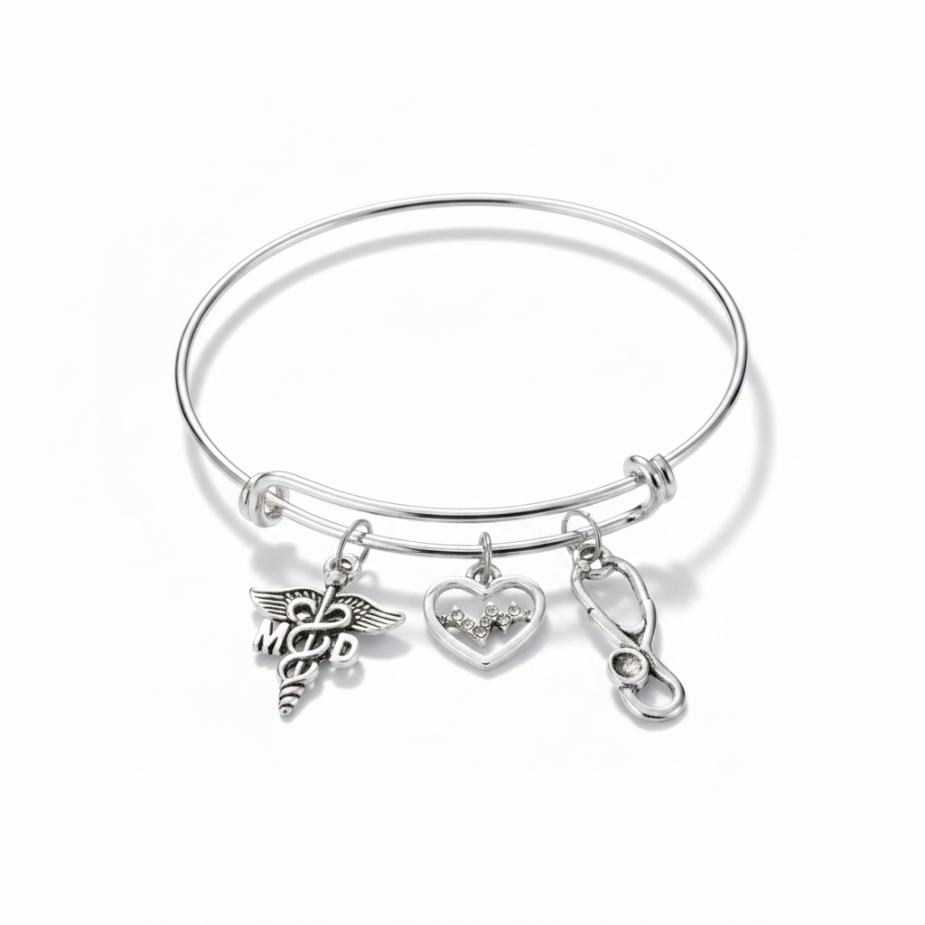 Silver expandable bangle bracelet with MD caduceus charm, crystal EKG heart charm, and stethoscope charm on white background — physician gift jewelry