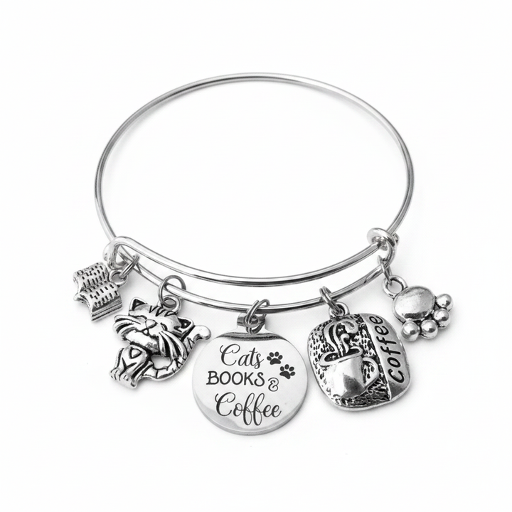 Silver expandable bangle bracelet with five charms: cat face, stack of books, engraved Cats Books &amp; Coffee disc with paw prints, coffee cup, and paw print charm — adjustable stackable gift bracelet for cat lovers and book lovers