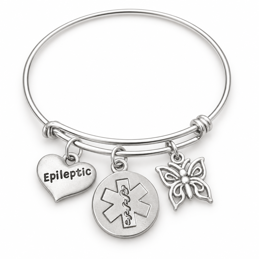 Silver epileptic medical alert bangle with engraved heart, round medical symbol and butterfly charms on a white background