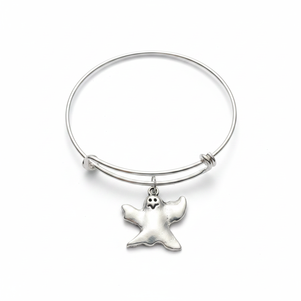 Full silver expandable wire bangle bracelet on white background with a whimsical silver ghost charm centered at the bottom, featuring dot eyes and open mouth expression