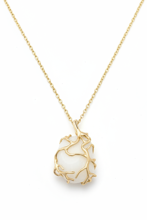 Lake Erie lucky stone necklace with smooth natural white oval stone set in an organic gold wire wrap cage pendant on a delicate gold cable chain, handcrafted by Jules Obsession in Port Clinton Ohio