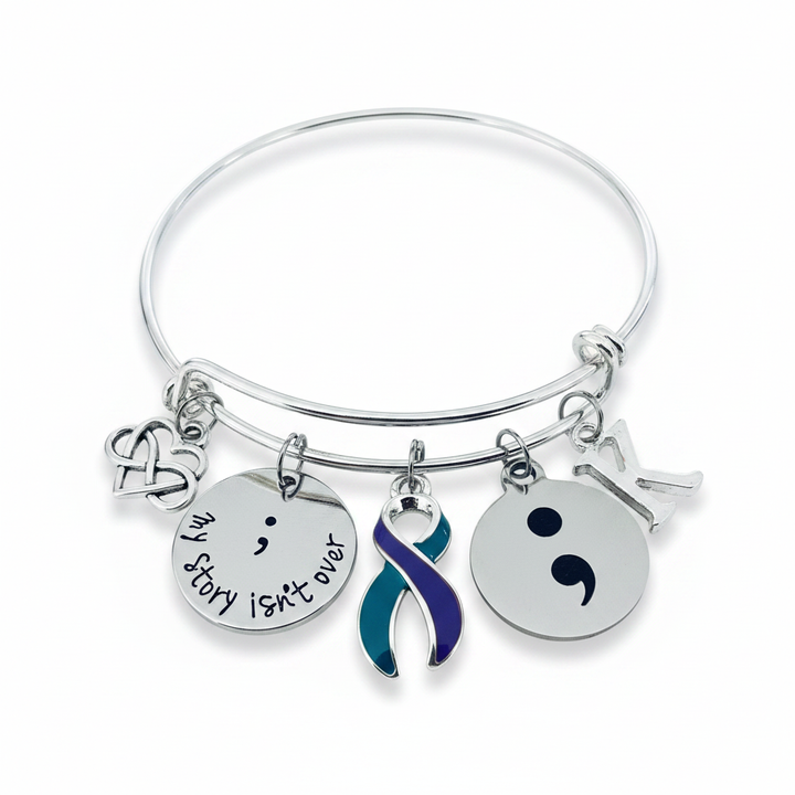 Silver expandable charm bangle bracelet for suicide prevention awareness, featuring a double infinity heart charm, a stamped disc reading my story isn&