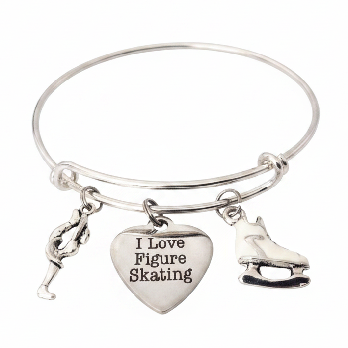 Silver expandable charm bangle bracelet with figure skater silhouette charm, I Love Figure Skating engraved heart charm, and white enamel ice skate boot charm, handcrafted by Jules Obsession