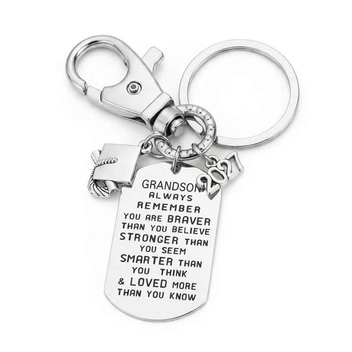 Silver-tone grandson graduation keychain with an inspirational engraved dog tag, graduation cap charm, 2027 year charm, key ring and lobster clasp.