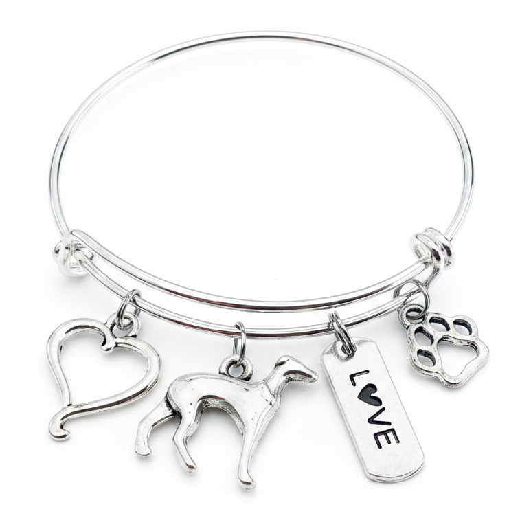 Silver expandable bangle bracelet with four antique silver charms: an open heart, a greyhound dog silhouette, a LOVE tag with heart, and a paw print, displayed on a white studio background