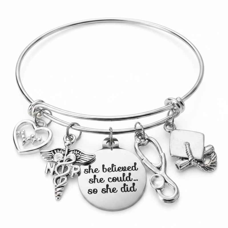 Silver expandable bangle bracelet with NP caduceus nurse practitioner charm, EKG heartbeat heart charm, she believed she could so she did engraved disc, stethoscope charm, and graduation cap charm — nurse practitioner graduation gift bracelet by Jules Obsession