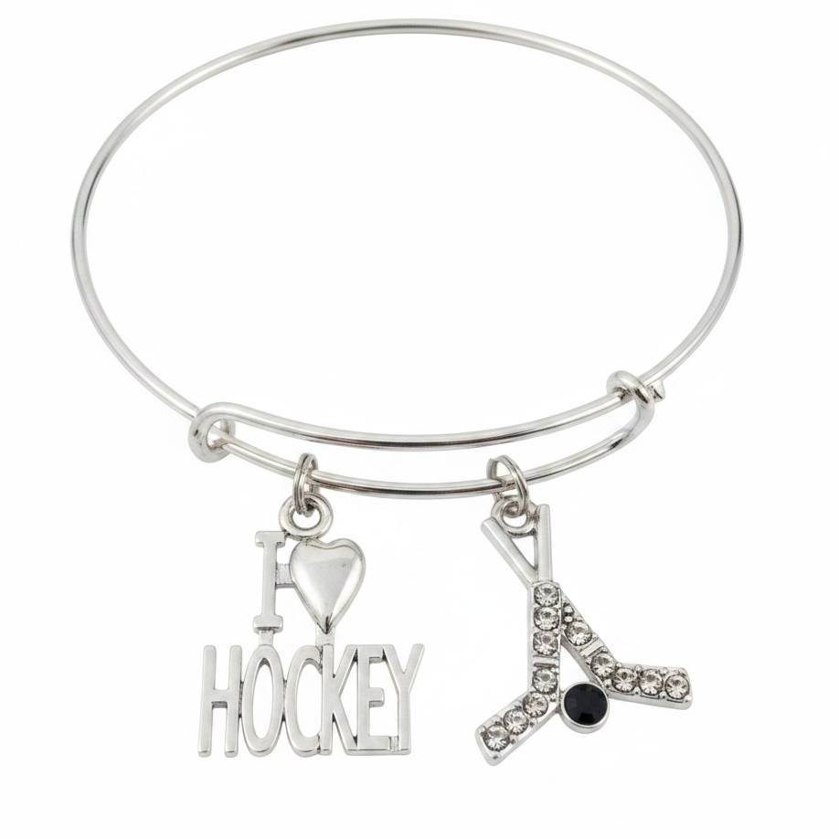 Silver expandable bangle bracelet with I Love Hockey word charm and crystal rhinestone crossed hockey sticks with black puck charm on white background – Jules Obsession hockey fan gift jewelry